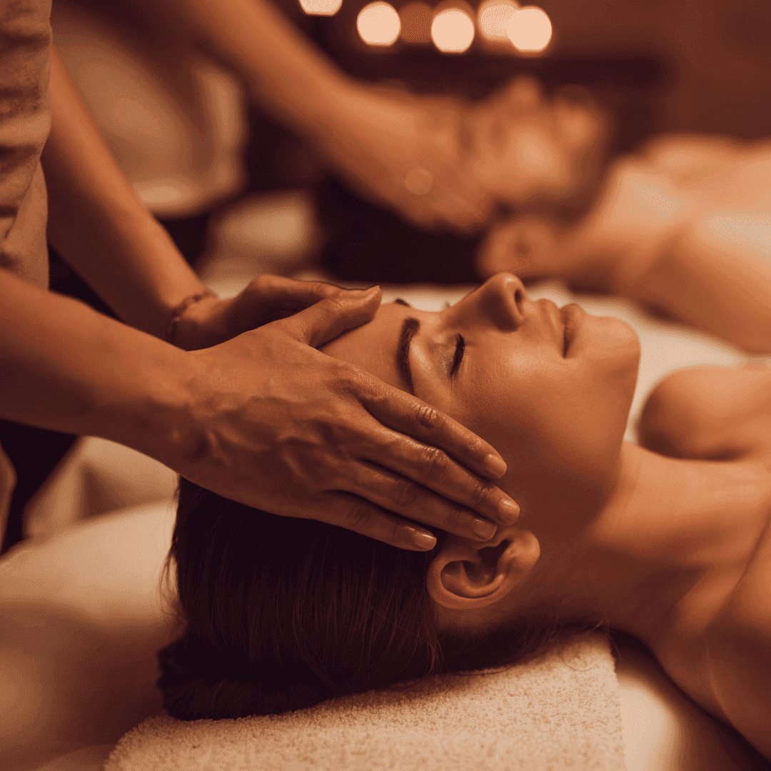 Relaxing head massage in tranquil spa setting with candles.