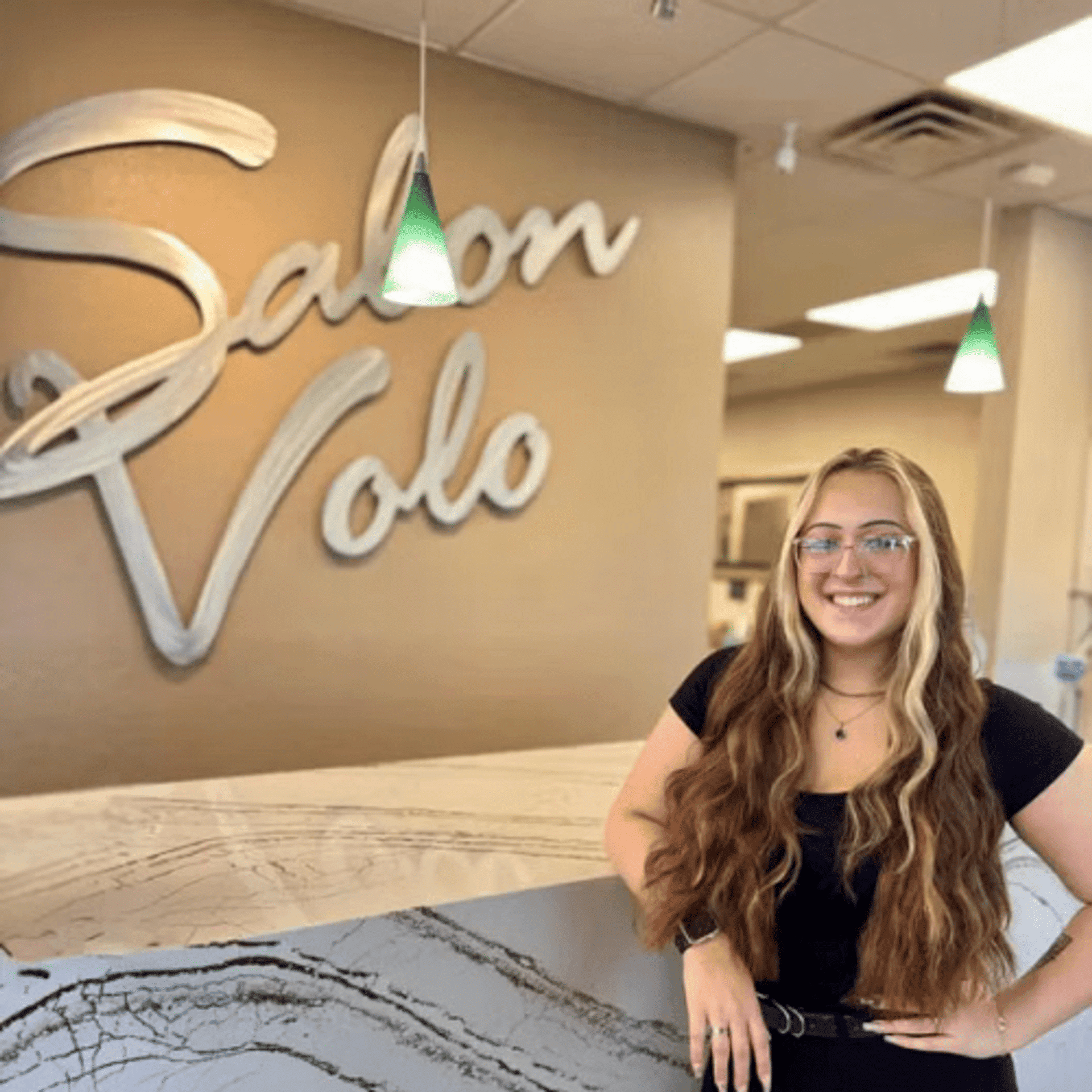 Portrait of Trinity Young, a professional stylist at Salon Volo Inc., showcasing their expertise and style.