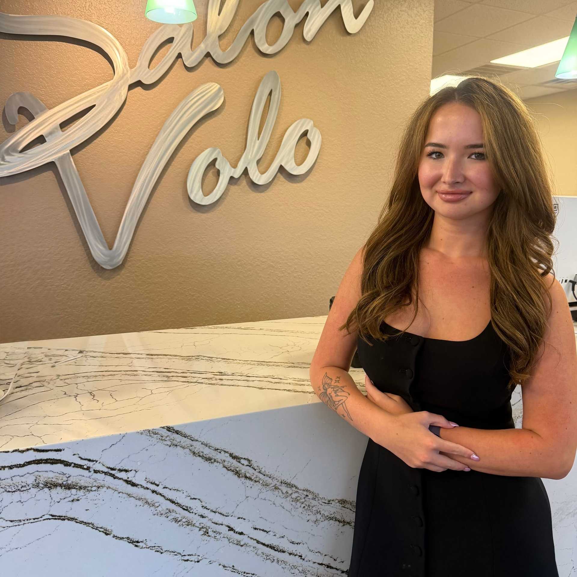Portrait of Alyssa Young, a professional stylist at Salon Volo Inc., showcasing their expertise and style.