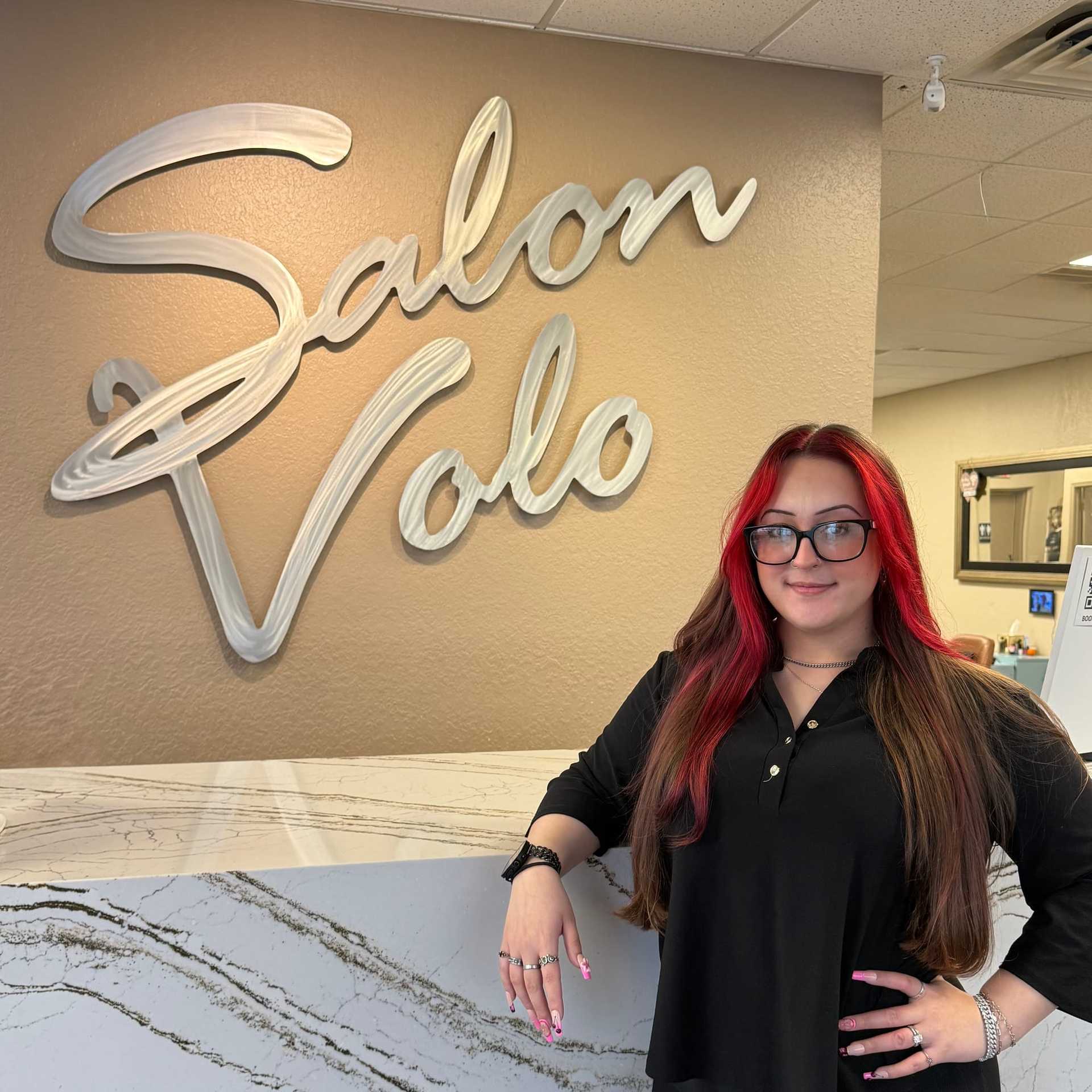 Portrait of Trinity Young, a professional stylist at Salon Volo Inc., showcasing their expertise and style.